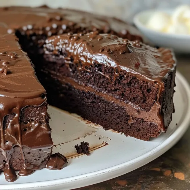 Detailed shot of a luscious vegan chocolate cake, showcasing its layers and frosting.