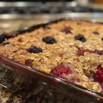 Juicy Berry Baked Oatmeal in a rustic bowl, highlighting the richness of oats and fruit.