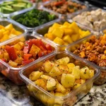 Vibrant breakfast meal prep bowl showcasing baby gold potatoes, ground chicken, and spices.
