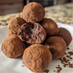 Detailed image of a chocolate truffle with a smooth texture and rich color.