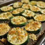 Juicy, quartered zucchini, baked and sprinkled with Parmesan cheese.