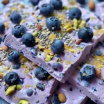 Juicy Blueberry Yogurt Bark displayed on a surface, showcasing the blueberries and yogurt texture.