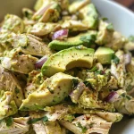 Fresh, colorful creamy avocado chicken salad arranged on a plate, showcasing its ingredients.