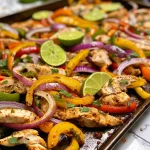 Tasty chicken fajitas served with tortillas, cilantro, and lime wedges on a cutting board.