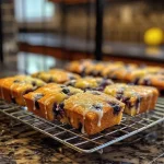 Juicy lemon blueberry mini loaves displayed on a wooden table, emphasizing their texture.