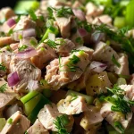 A vibrant, creamy tuna salad with fresh ingredients in a bowl.