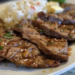 A vibrant dish of honey garlic butter steak and rice, showcasing tender meat and grains.
