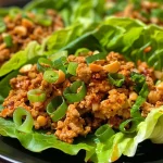 ['Close-up of Spicy Turkey Lettuce Cups filled with turkey, water chestnuts, and green onions.', 'Side view of juicy Spicy Turkey Lettuce Cups garnished with peanuts and herbs.', 'Delicious Spicy Turkey Lettuce Cups wrapped in crisp lettuce leaves on a plate.', 'A vibrant arrangement of Spicy Turkey Lettuce Cups showcasing colorful ingredients.']