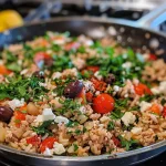 ['A close-up view of a skillet filled with ground turkey and rice, garnished with green beans and diced tomatoes.', 'Juicy ground turkey and rice mixed with fresh green beans, showcased in a cast-iron skillet.', 'A vibrant dish of ground turkey and rice, topped with diced tomatoes and vegetables in a frying pan.', 'Side view of a delicious ground turkey and rice skillet, complete with green beans and herbs.']