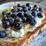 Close-up view of whipped blueberry cottage cheese toast on toasted bread.