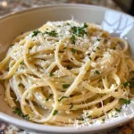 ['Close-up photo of creamy garlic parmesan pasta with a rich sauce and parsley garnish.', 'Side view of a bowl filled with creamy garlic parmesan pasta, showcasing its smooth texture and ingredients.', 'Juicy creamy garlic parmesan pasta featuring a sprinkle of parsley and a glossy sauce.', 'Detailed shot of delicious creamy garlic parmesan pasta, highlighting the garlic and cheese blend.']